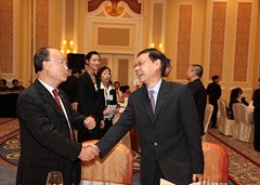 澳門緬華互助會會長黃國賢（右）向澳門潮州同鄉會理事長陳新濤握手問好